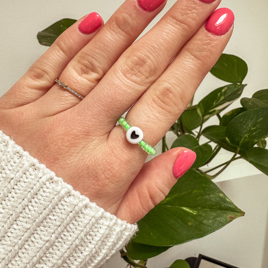 Perlenring aus grünen Glasperlen mit Herz in Schwarz