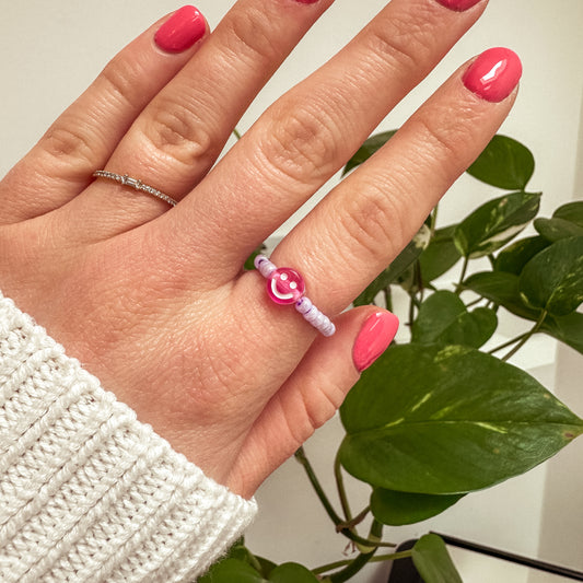 Perlenring aus Glasperlen in Flieder mit Smiley in Pink
